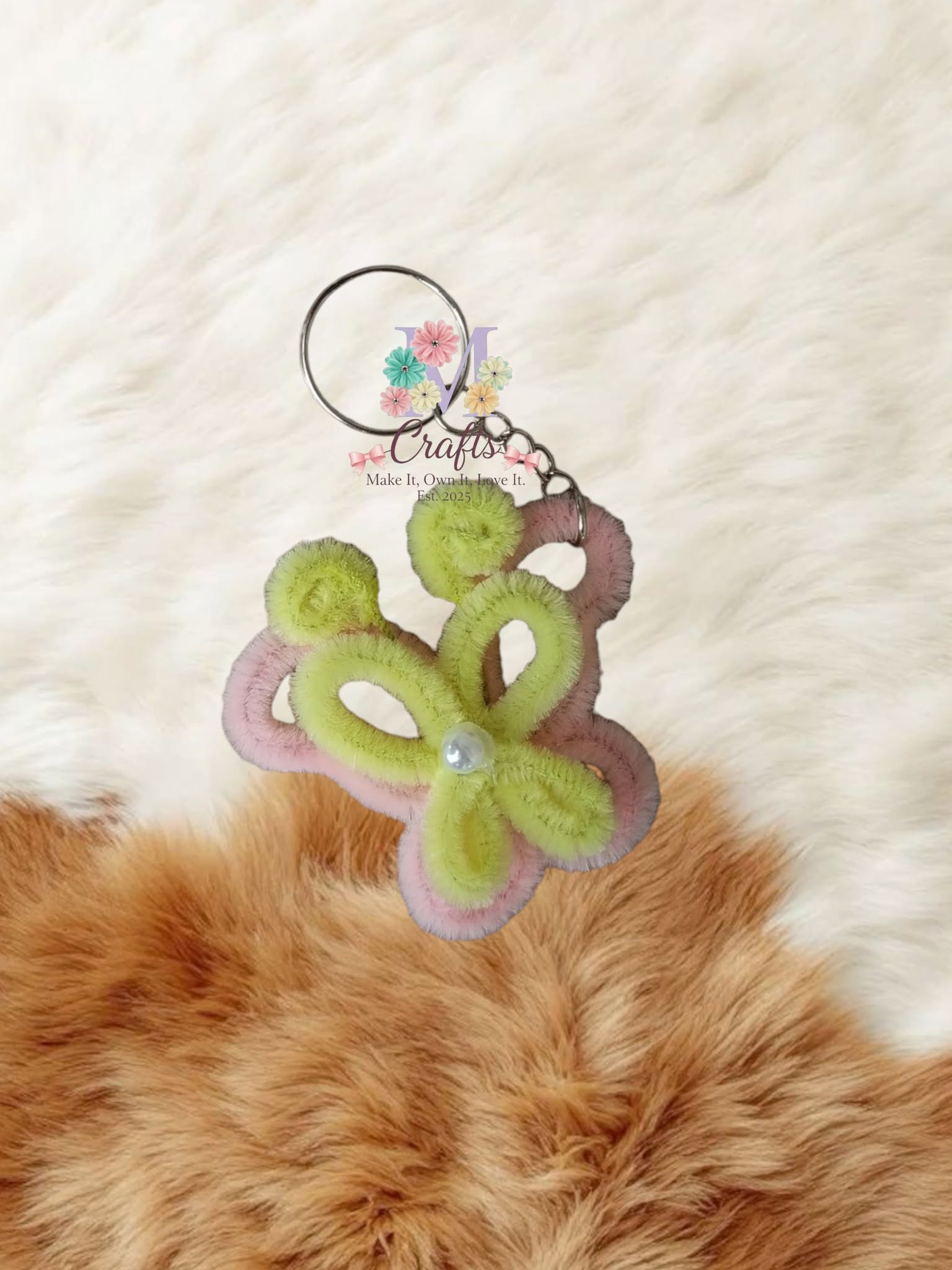 Pistachio butterfly keychain edged in pink with a pearl body